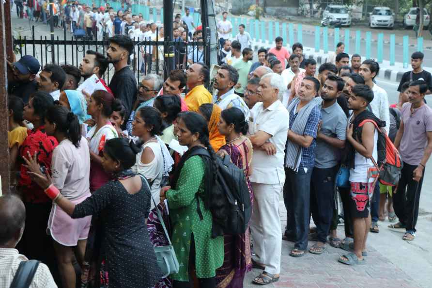 Jammu: Pilgrims wait in a queue to get themselves registered for...