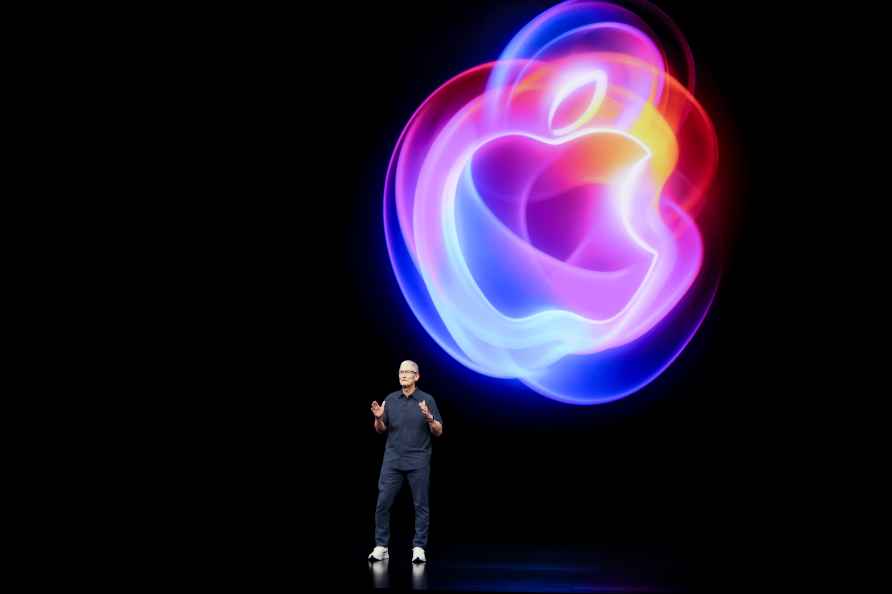 Apple CEO Tim Cook talks on the stage during an announcement of ...