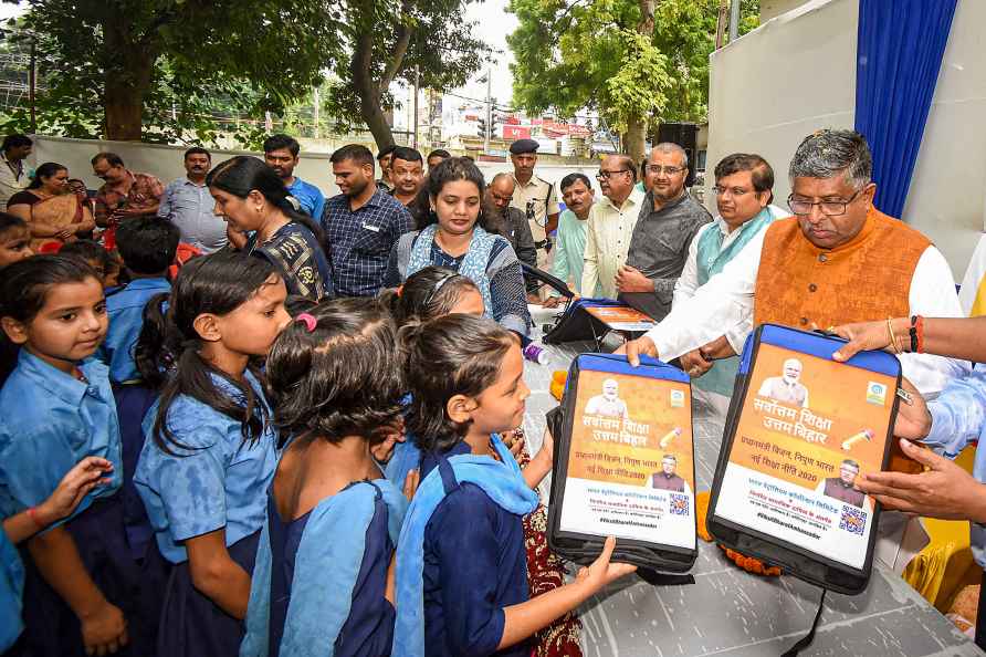 Ravi Shankar distributes bags to school students