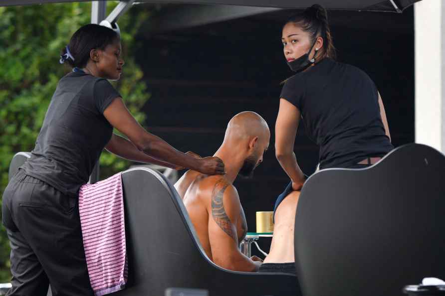 Andrew Tate gets a massage outside his residence