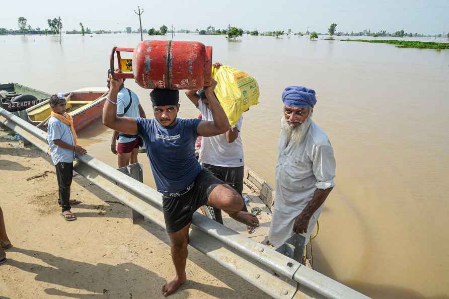 Jalandhar: Residents shift to a safer place from a flood-affected...