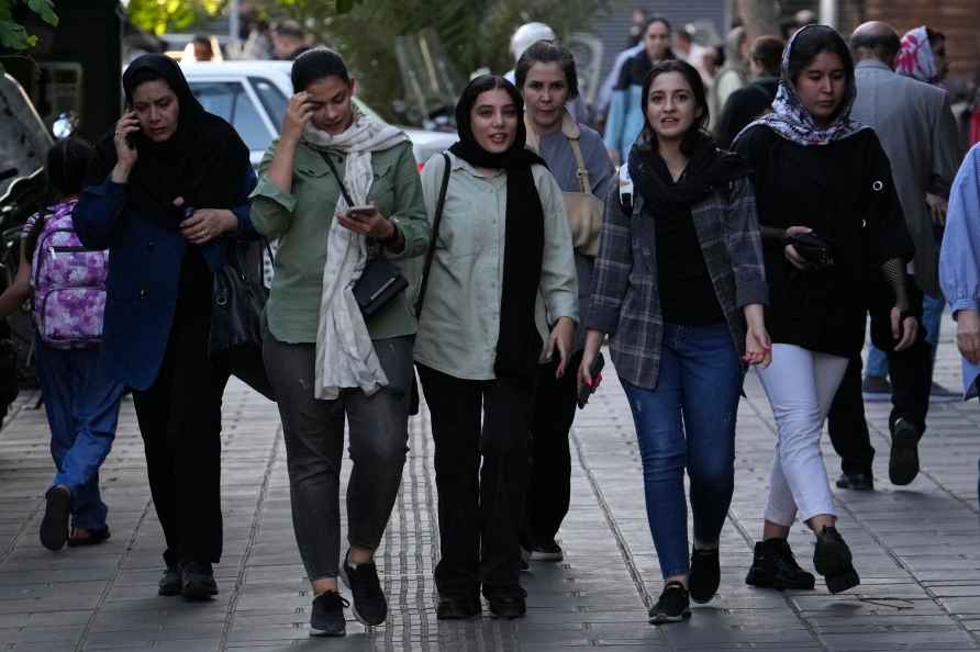 Iranian women, some without wearing their mandatory Islamic headscarves...