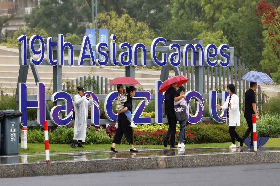 People walk near the Hangzhou Olympic Sports Centre Stadium before...