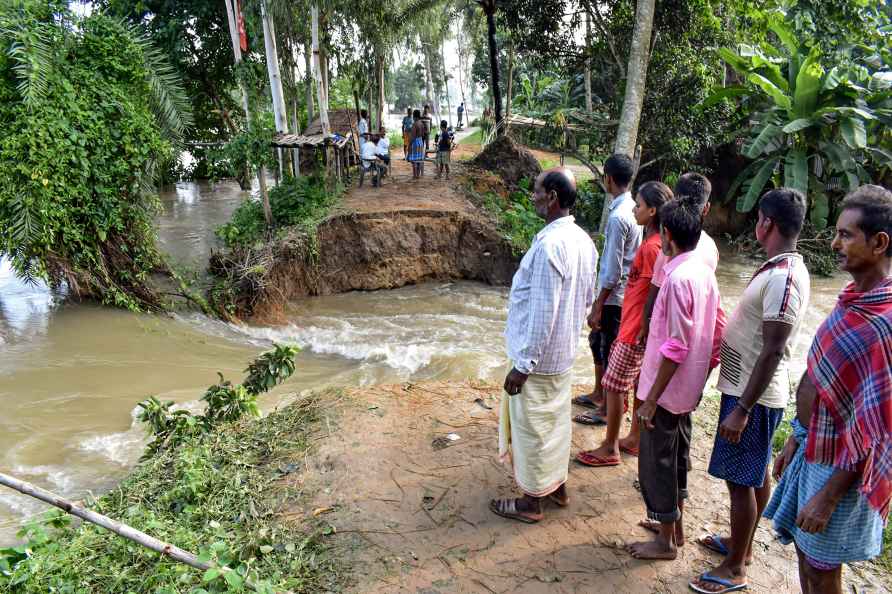 Malda: Locals gather as the water of the River Tangon rushes into...