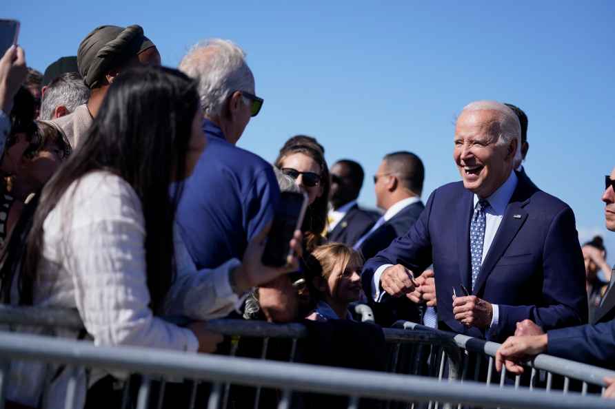 President Joe Biden greets supporters on the tarmac as he arrives...