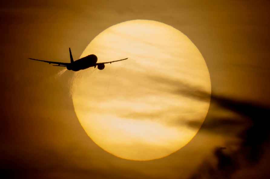 An aircraft passes the sun