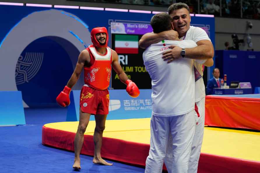 Iran's Afshin Salimi Toupghara, left, celebrates after his win against...