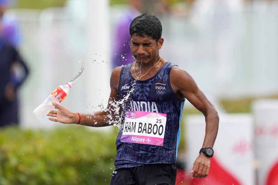 India's Ram Babo cools himself as he competes during the mixed teams...