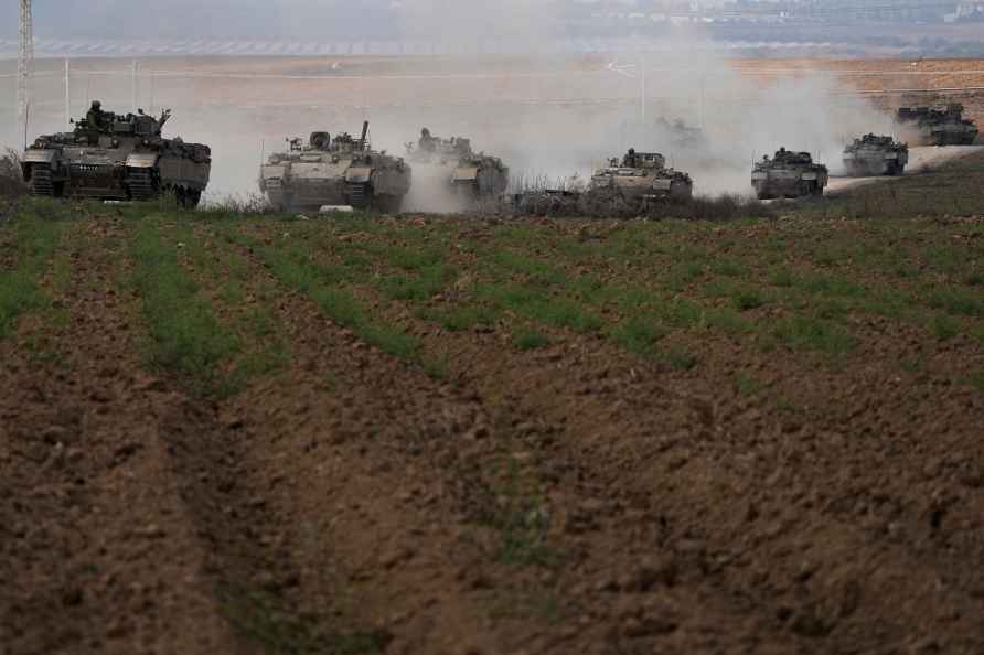 Israeli armoured personnel carriers (APC) head towards the Gaza Strip