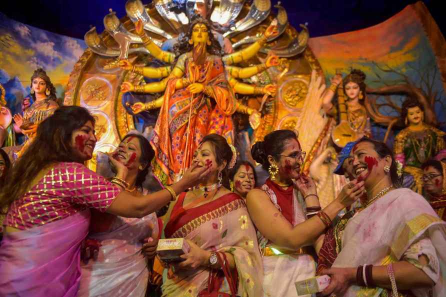 Kolkata: Devotees put vermilion on each other at a community 'puja...