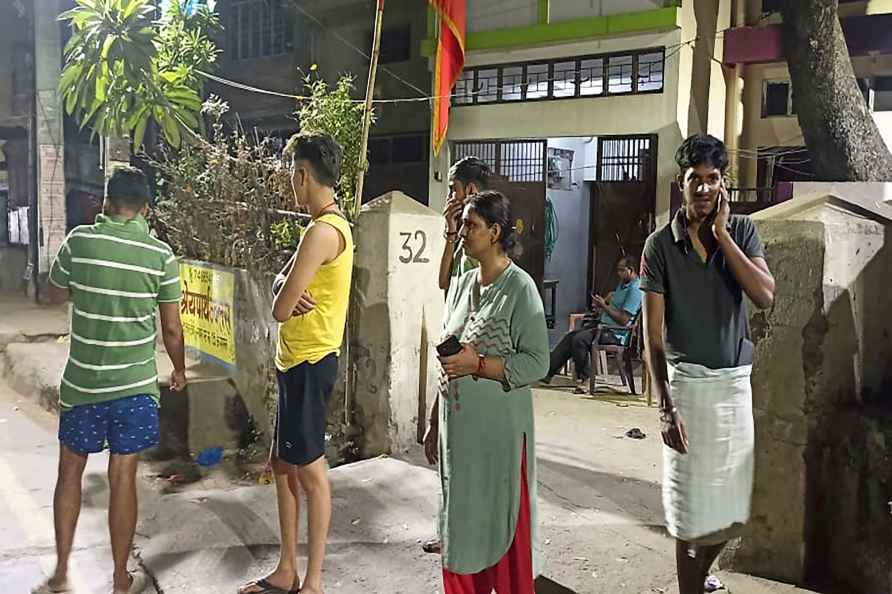 Patna : People gather outside their offices after tremors were felt...