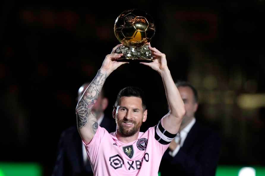 Inter Miami forward Lionel Messi holds his Ballon d'Or trophy before...