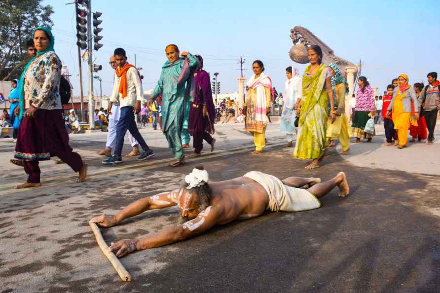 Ayodhya: A devotee moves while lying in prostrate position at 'Parikrama...