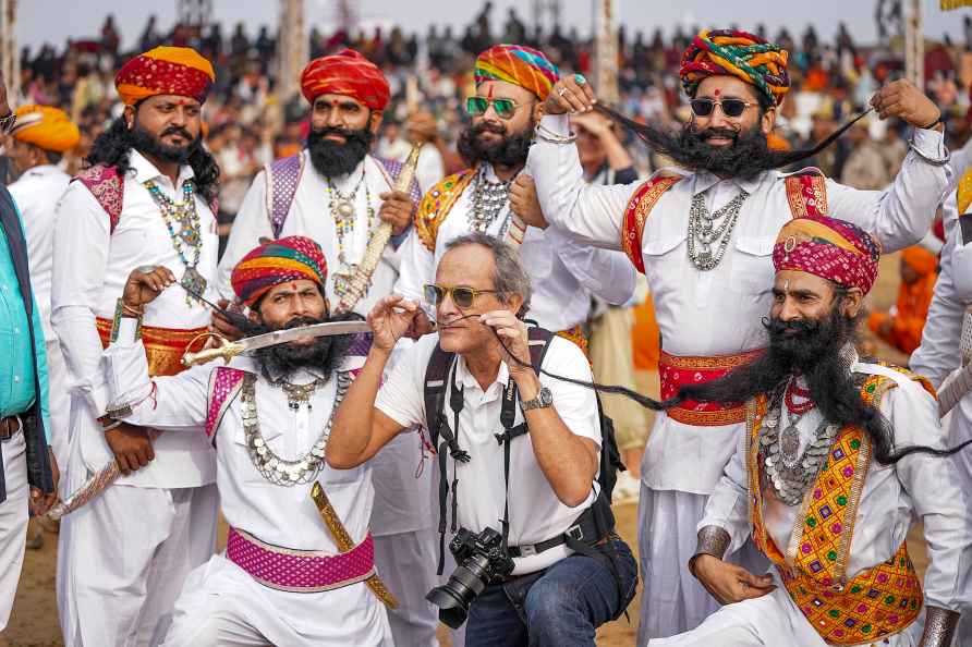 Pushkar: Rajasthani artists pose for group photos at the closing...