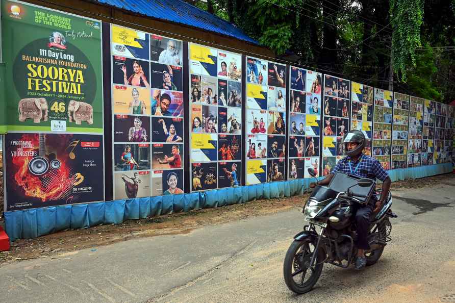 Thiruvananthapuram: A motorcyclist rides past banners regarding ...