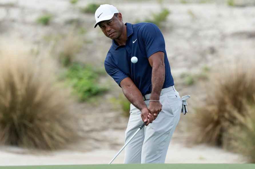 Tiger Woods watches his shot during a practice round of the Hero...