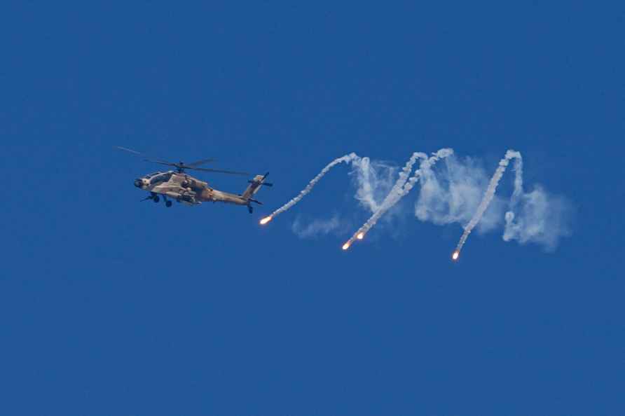 An Israeli military helicopter releases flares