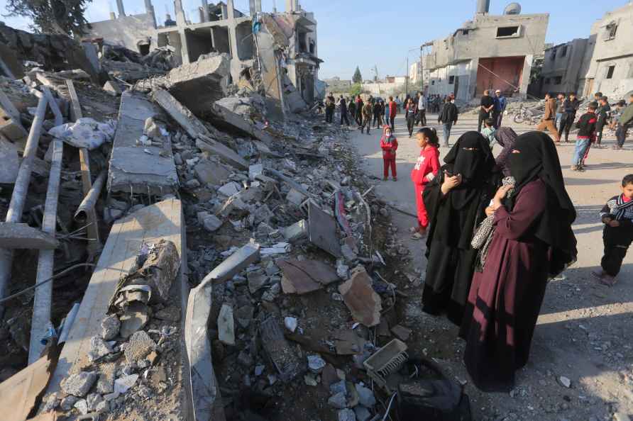 Palestinians look at the destruction by the Israeli bombardment ...