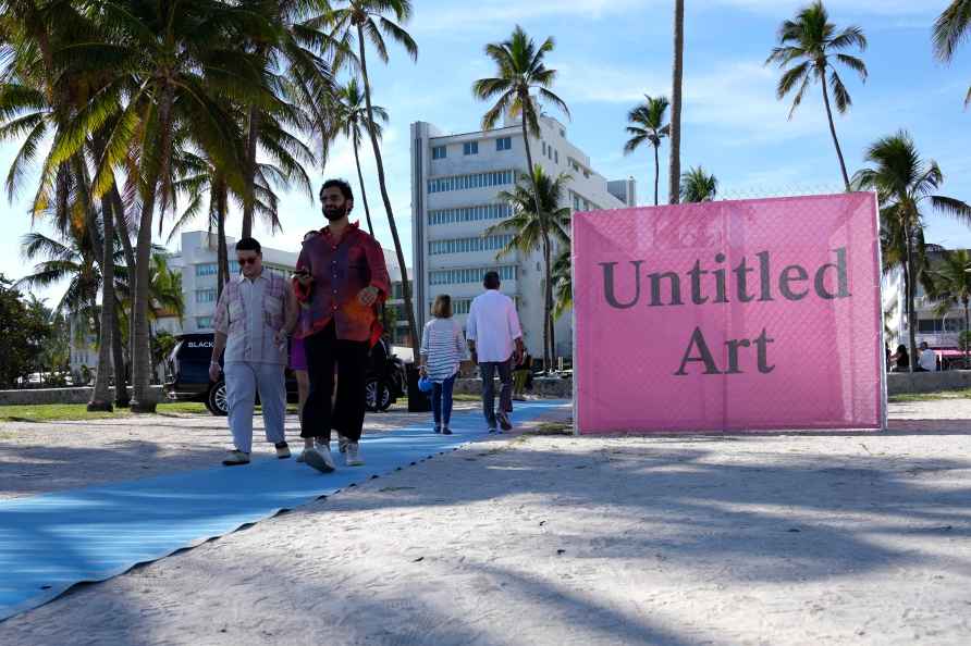 People arrive for the Untitled Art fair during Miami Art Week, Tuesday...