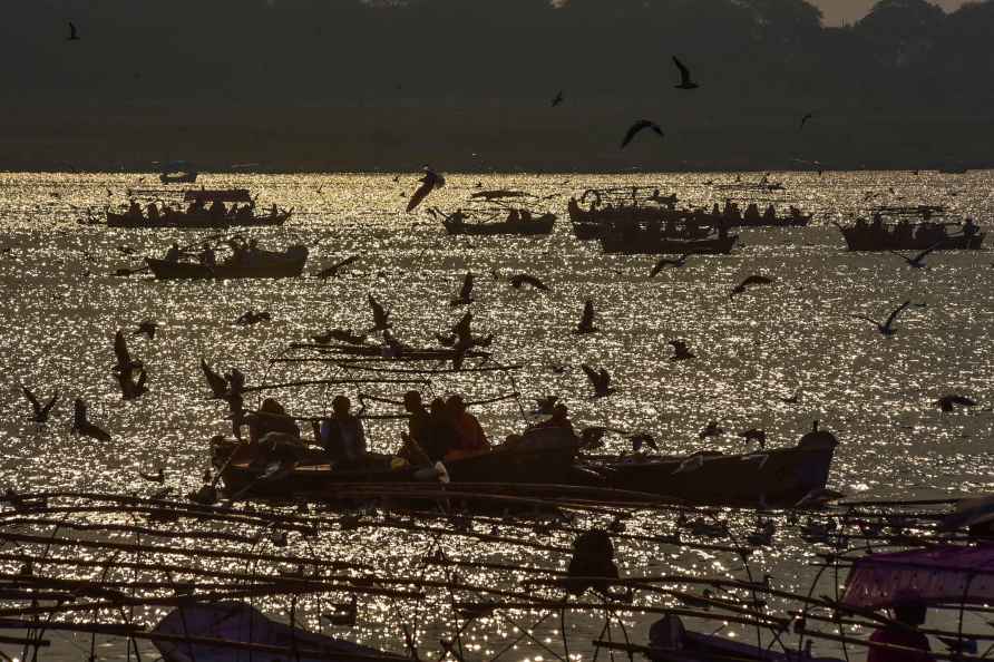 Prayagraj: Hindu devotees take a boat ride as seagulls fly ahead...