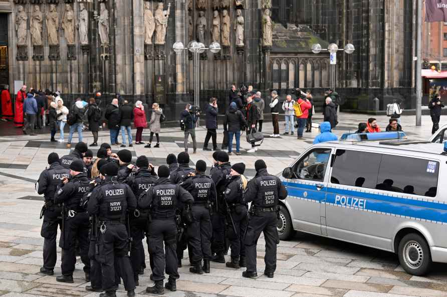 Police officers patrol the entrance of Cologne Cathedral ahead of...