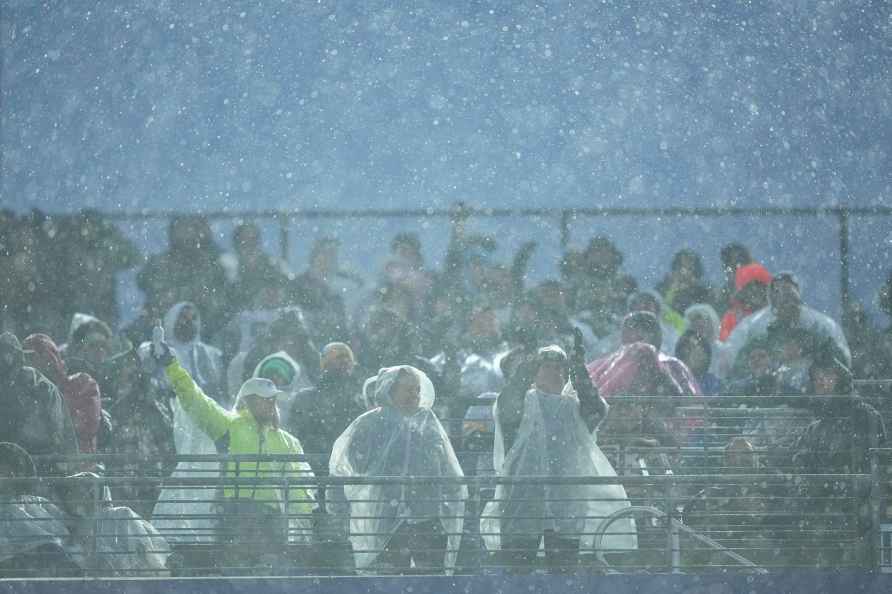 Rain falls on spectators prior to an NFL football game between the...