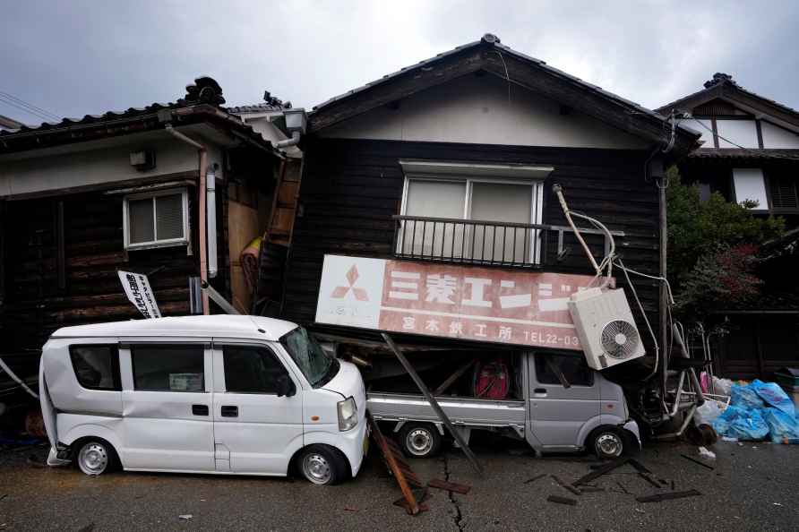 Crashed vehicles by collapsed houses