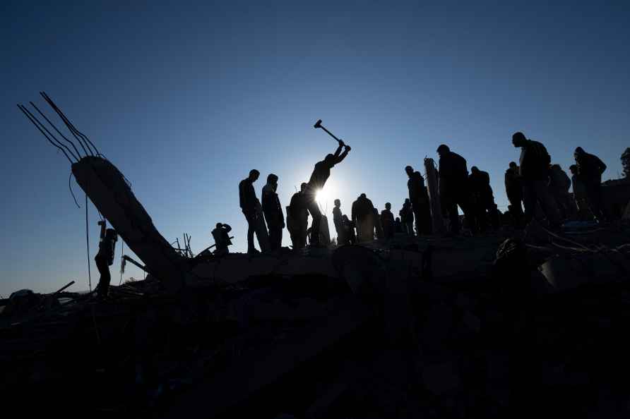 Palestinians search for bodies and survivors in the rubble of a ...