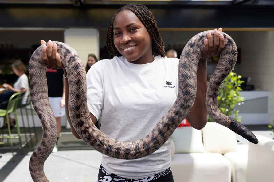 Coco Gauff of the U.S. meets Casper the black headed python in the...