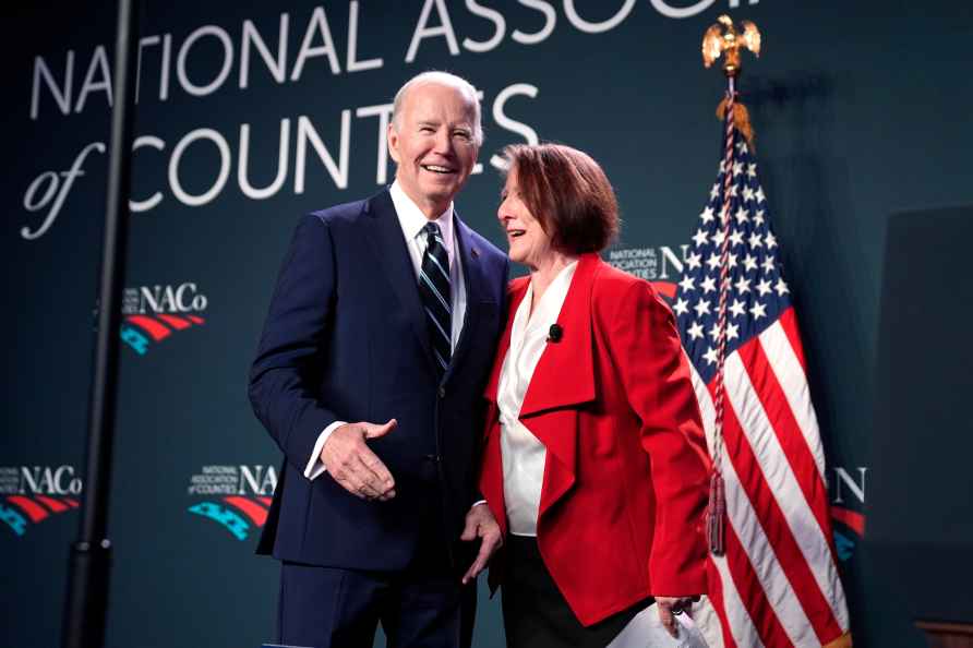 President Joe Biden, left, greets NatCo president and commissioner...