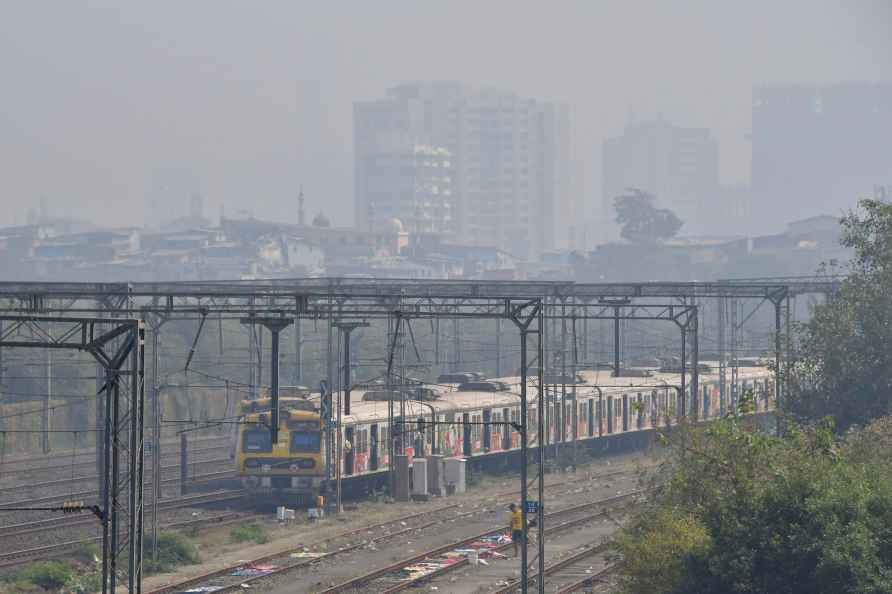 Mumbai: A train passes by amid smog, at Bandra, in Mumbai, Friday...