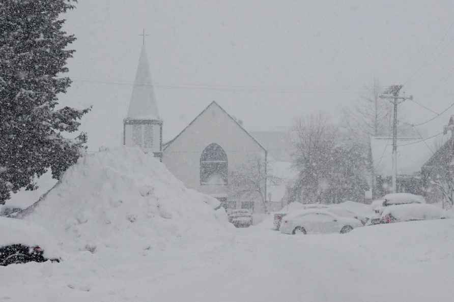 Snow piles up in front of a church