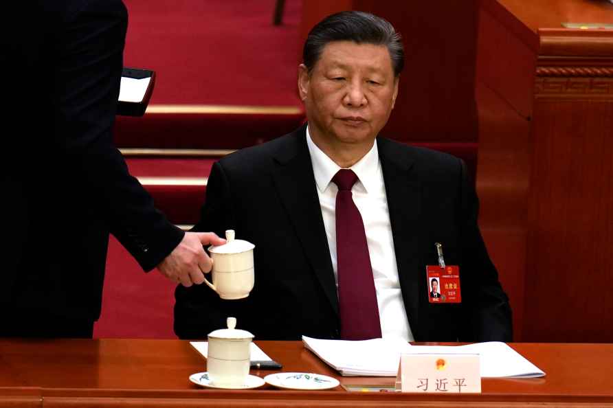 Chinese President Xi Jinping looks on as he is served a drink during...