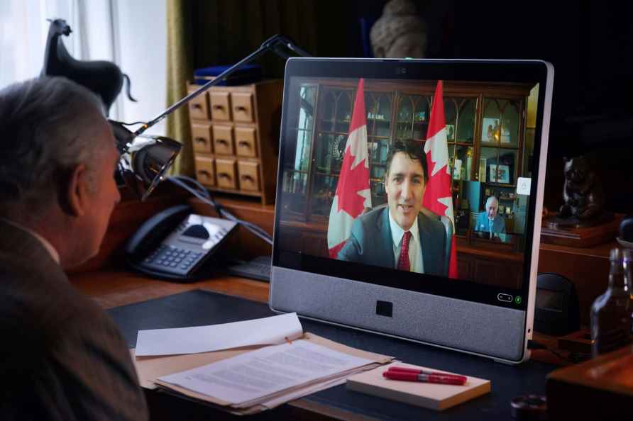 Britain's King Charles III speaks to Canadian Prime Minister Justin...