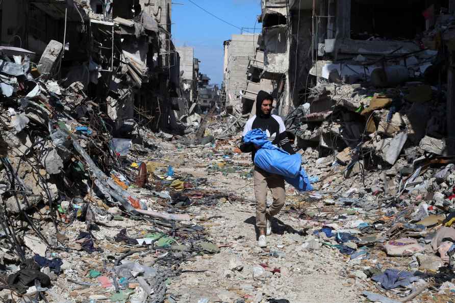 Palestinian walks through the destruction