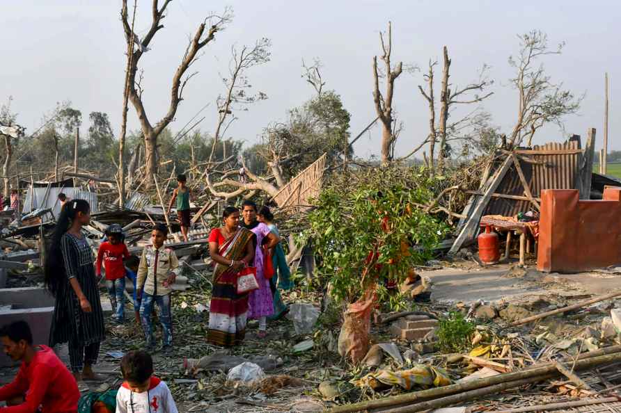 Villagers at damaged houses after storm