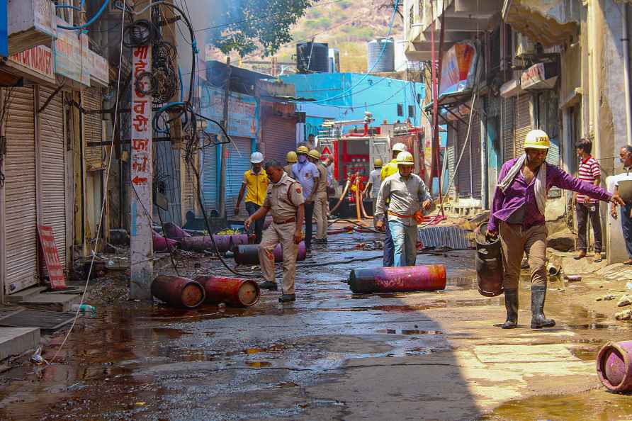 Ajmer: Fire fighters shift LPG cylinders after a massive fire broke...