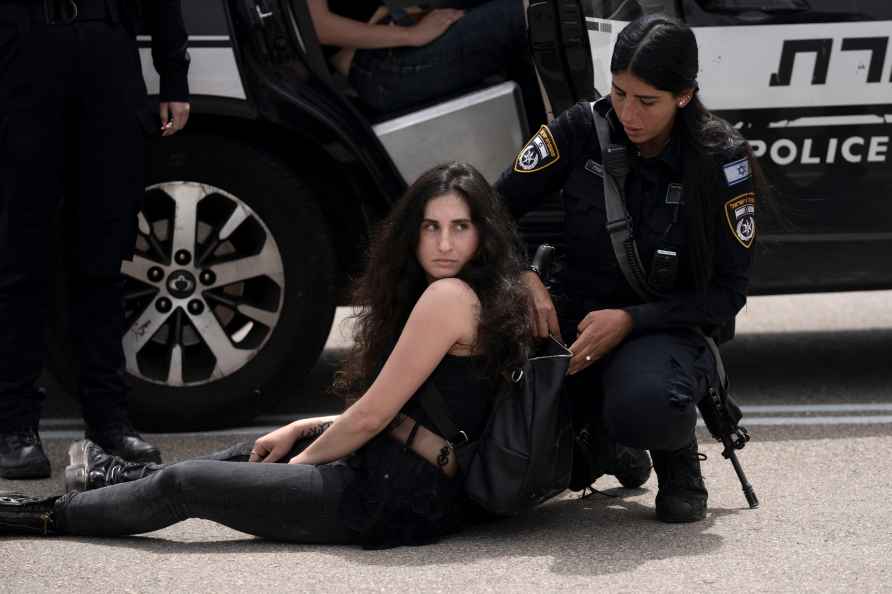 Israeli police officer searches an activist