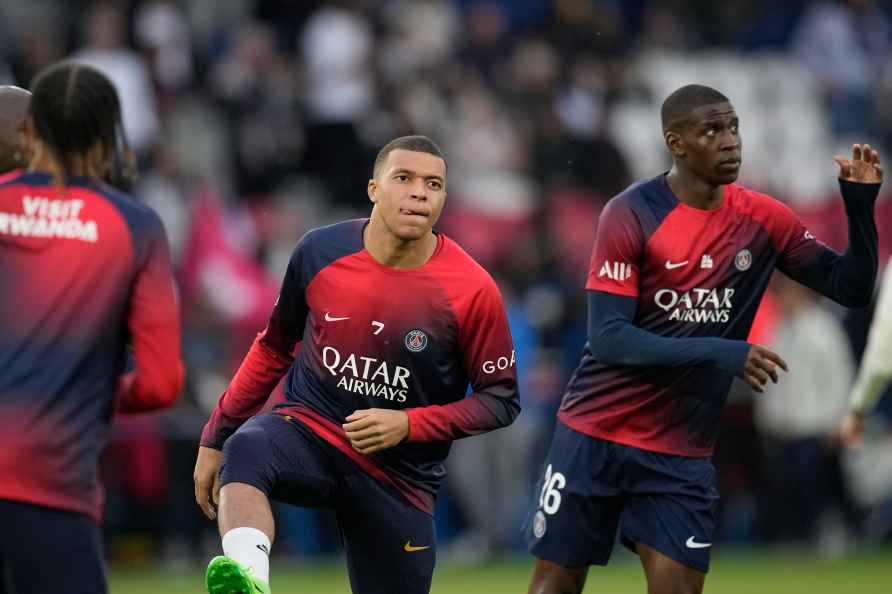 PSG's Kylian Mbappe, centre, warms up before the French League One...