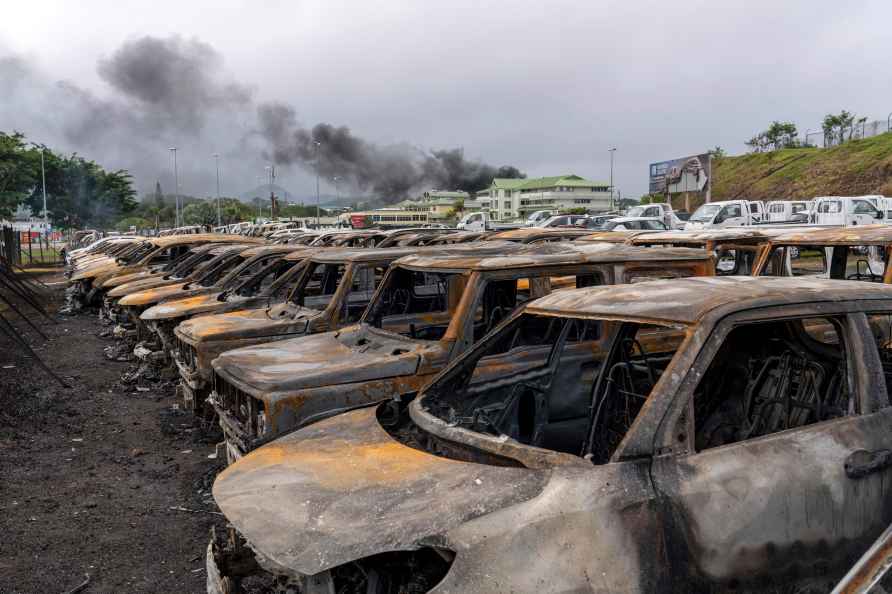 Burnt cars are lined up after unrest in Noumea