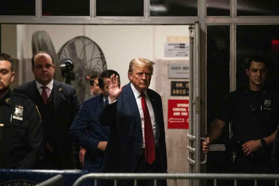 Former President Donald Trump gestures as he returns to court after...