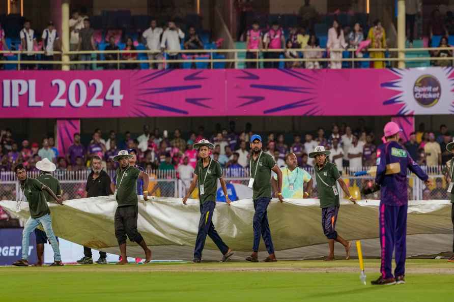 Guwahati: Ground staff covers the field as rain delays the Indian...