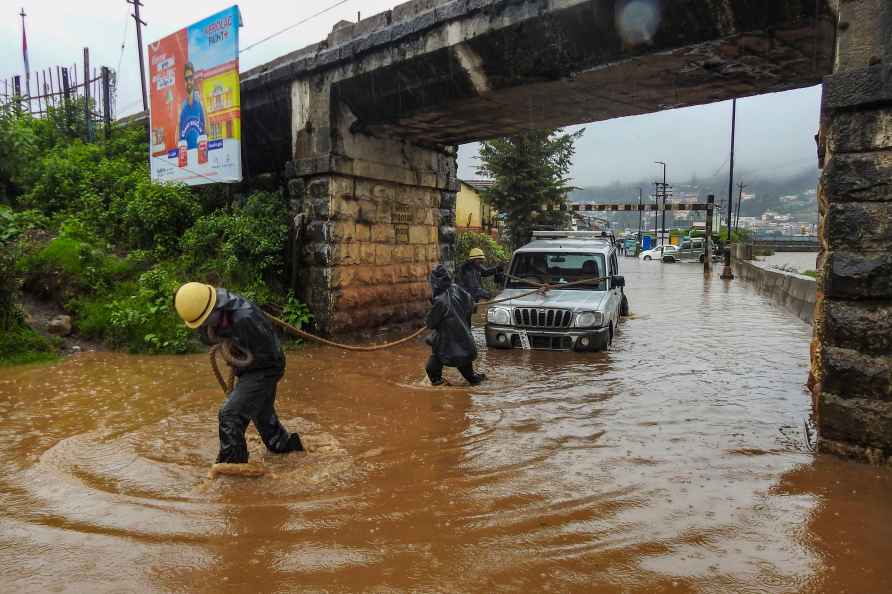 Ooty: Firefighters rescue people stuck in a vehicle on a waterlogged...