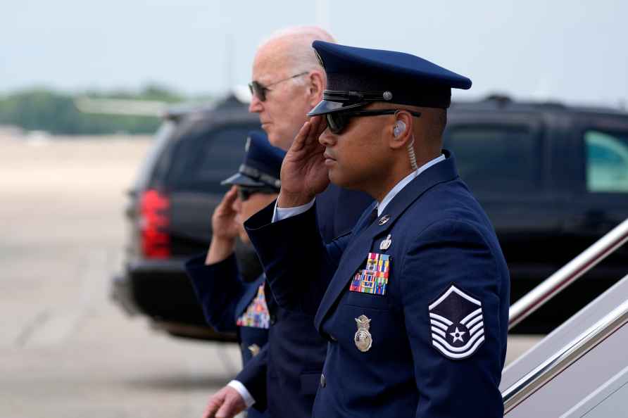 President Joe Biden, in background, arrives on Air Force One, Monday...