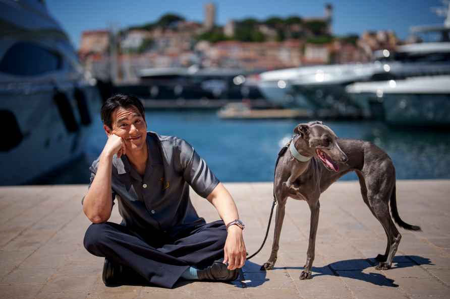 Eddie Peng poses with his dog Xin during an interview for the film...