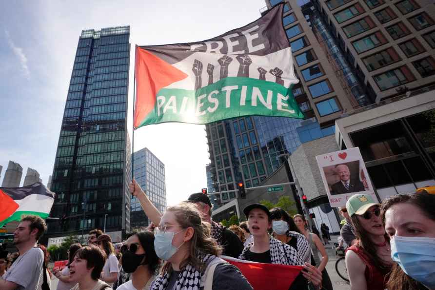 Demonstrators display Palestinian flags and chant slogans while ...