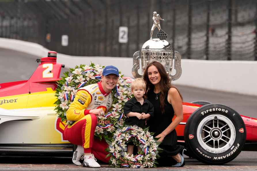 Josef Newgarden poses with the Borg-Warner Trophy with his son, ...