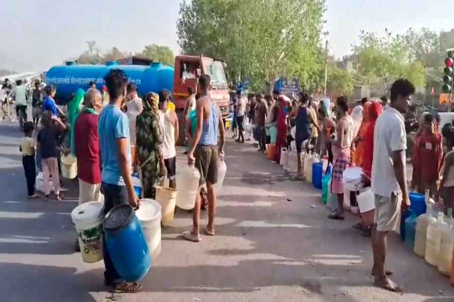 **EDS: VIDEO GRAB** New Delhi: People wait in queues to collect ...