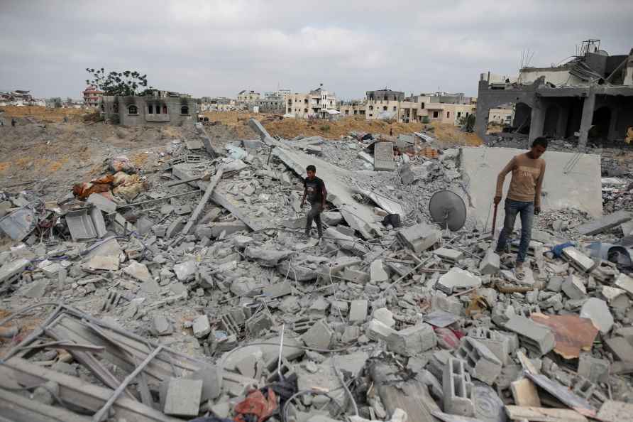 Palestinians look at the destruction