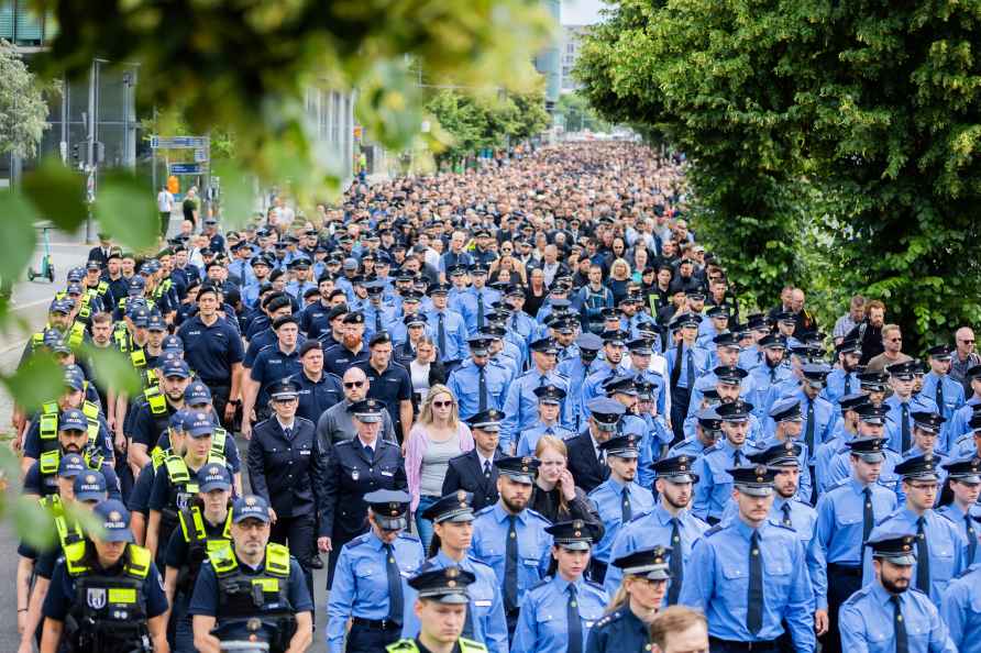 Police officers take part in a silent march organized by the 